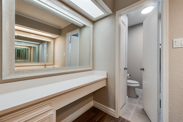 bathroom featuring wood-type flooring and toilet