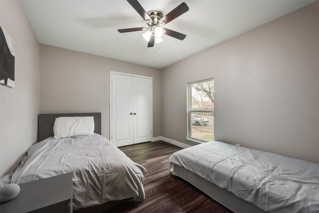 bedroom with a closet, ceiling fan, and dark hardwood / wood-style floors