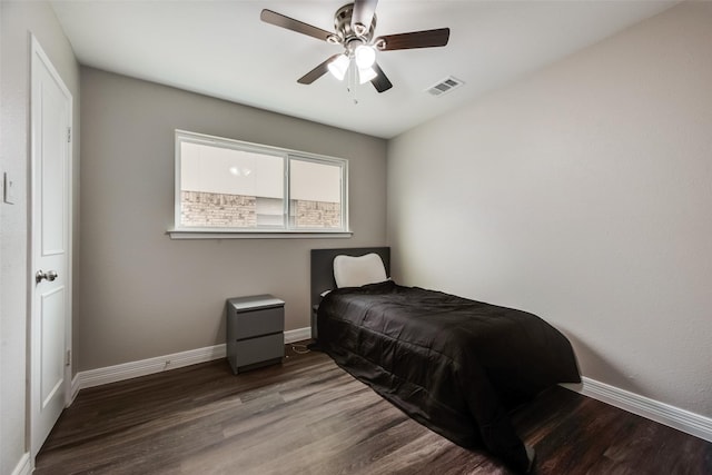 bedroom with ceiling fan and dark hardwood / wood-style flooring