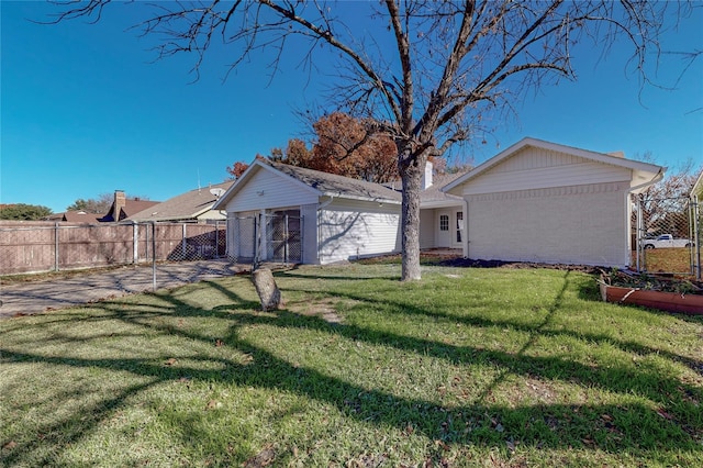 rear view of property featuring a yard and an outdoor structure