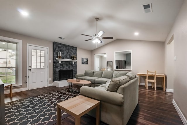 living room with ceiling fan, dark hardwood / wood-style flooring, lofted ceiling, and a fireplace