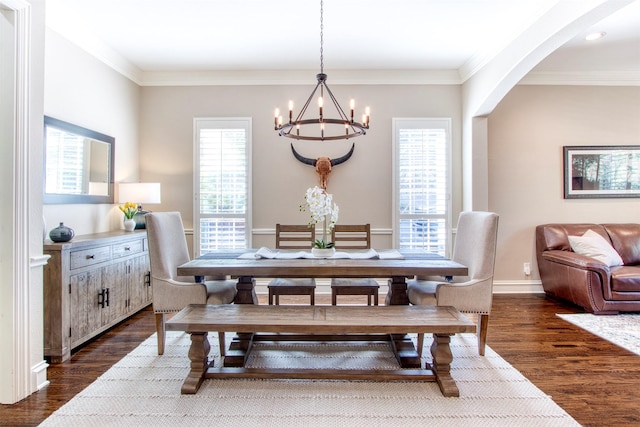 dining space featuring dark hardwood / wood-style flooring, a wealth of natural light, and ornamental molding