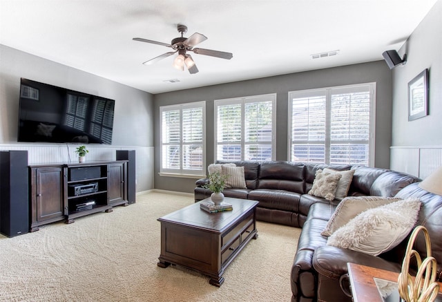 carpeted living room featuring ceiling fan