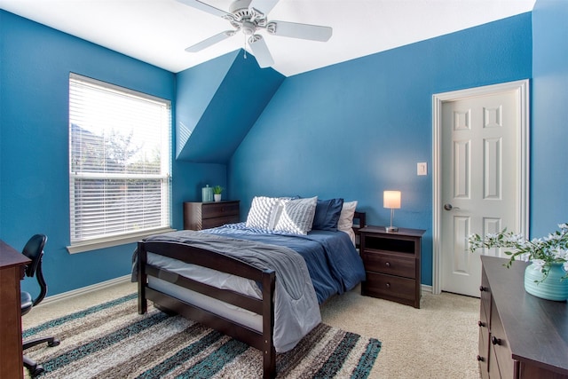 bedroom featuring lofted ceiling, light colored carpet, and ceiling fan