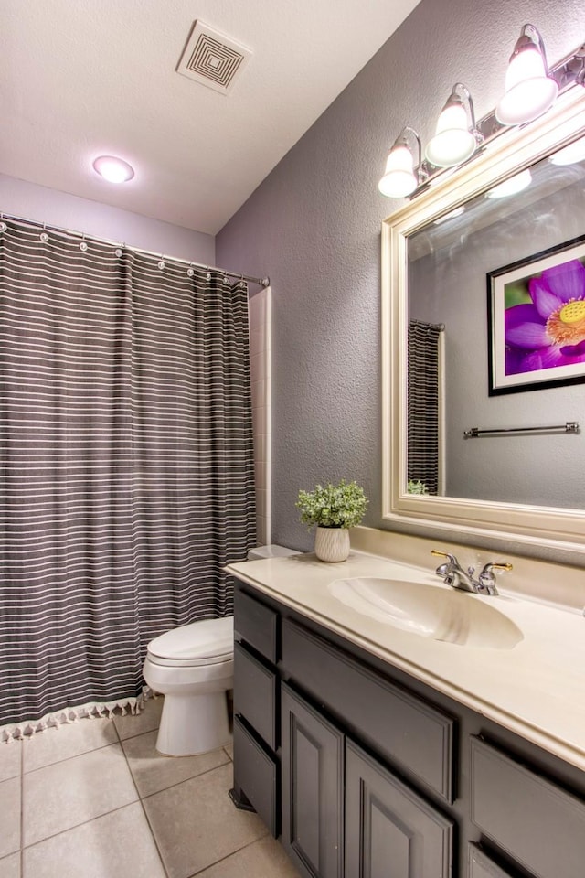 bathroom featuring vanity, a shower with curtain, tile patterned floors, and toilet