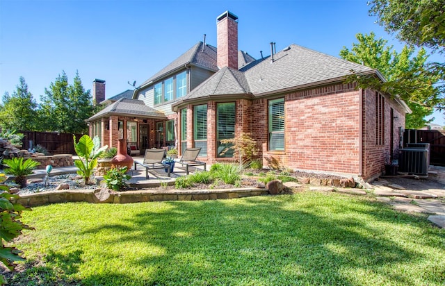 rear view of property featuring a patio area, central air condition unit, and a lawn