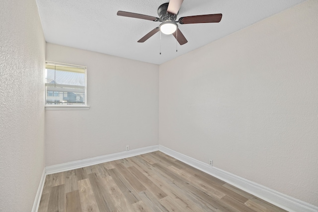 empty room with light hardwood / wood-style flooring and ceiling fan