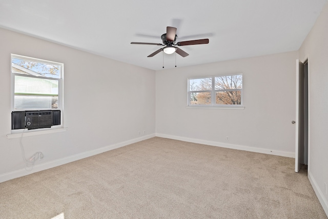 spare room featuring cooling unit, ceiling fan, and light carpet