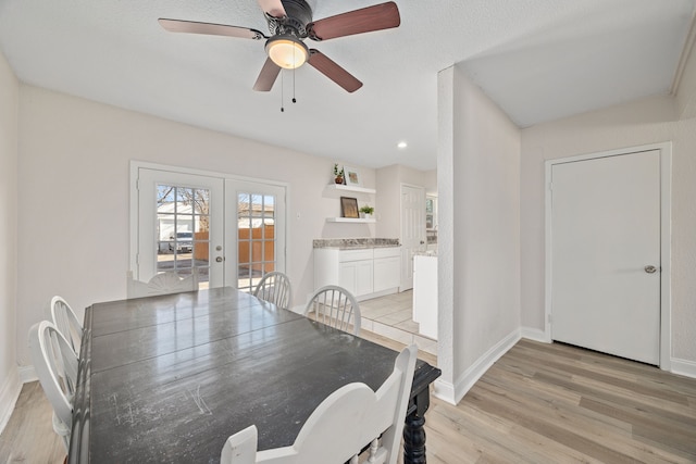 dining area featuring ceiling fan, french doors, and light wood-type flooring