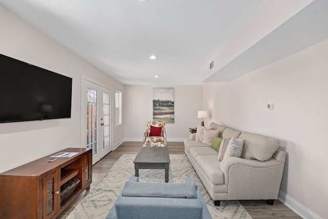 living room with hardwood / wood-style floors and french doors