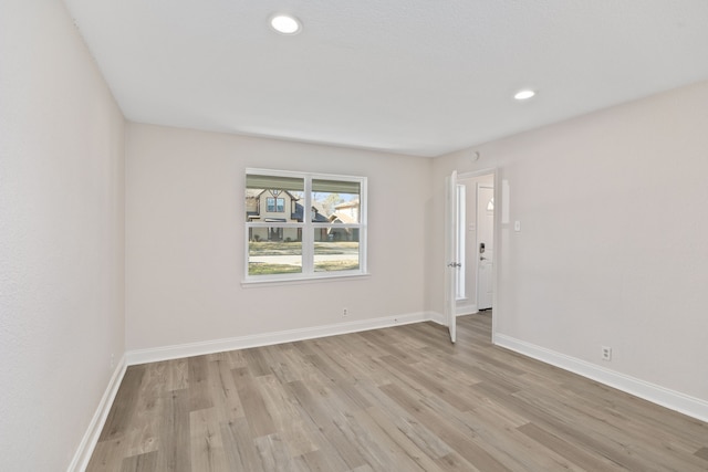 spare room with light hardwood / wood-style flooring