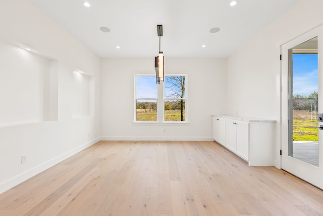 unfurnished dining area featuring light hardwood / wood-style floors