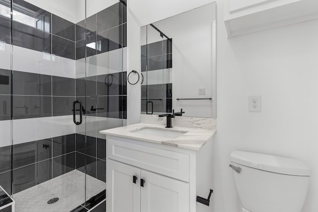 bathroom featuring toilet, walk in shower, and vanity