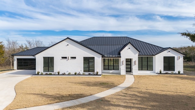 modern farmhouse with a garage and a front lawn