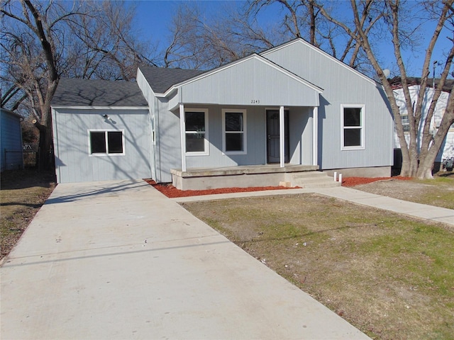 view of front of home with a porch and a front yard