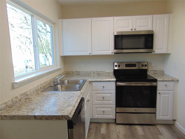 kitchen featuring sink, white cabinets, and appliances with stainless steel finishes