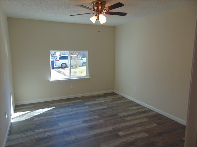 empty room with ceiling fan, dark hardwood / wood-style floors, and a textured ceiling