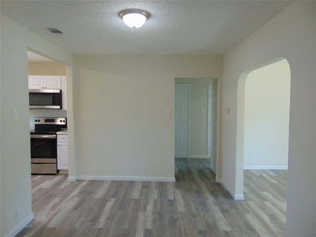 interior space with light hardwood / wood-style floors and a textured ceiling