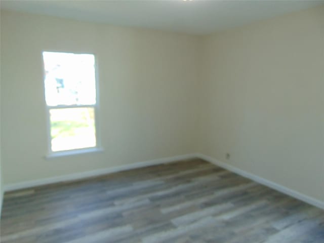 unfurnished room with wood-type flooring