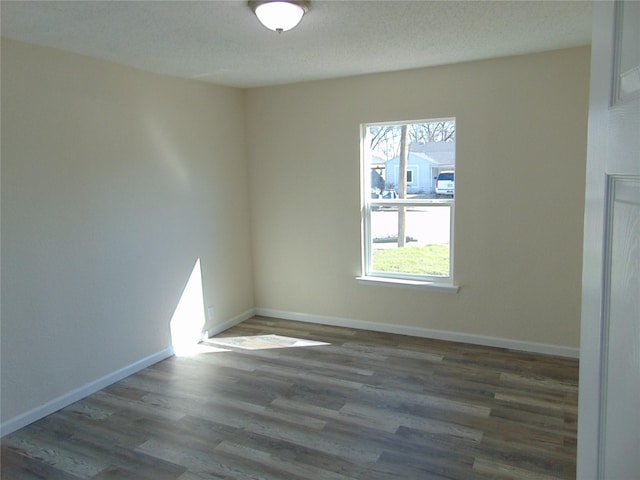 unfurnished room featuring dark wood-type flooring