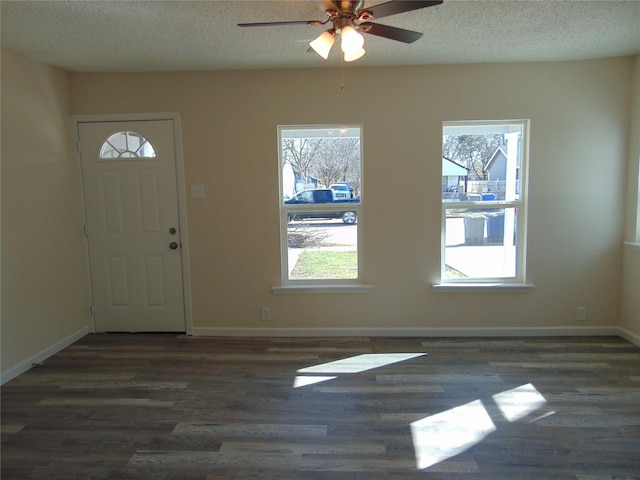 entrance foyer featuring ceiling fan, dark hardwood / wood-style flooring, and a textured ceiling