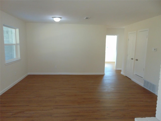 unfurnished room featuring dark hardwood / wood-style floors