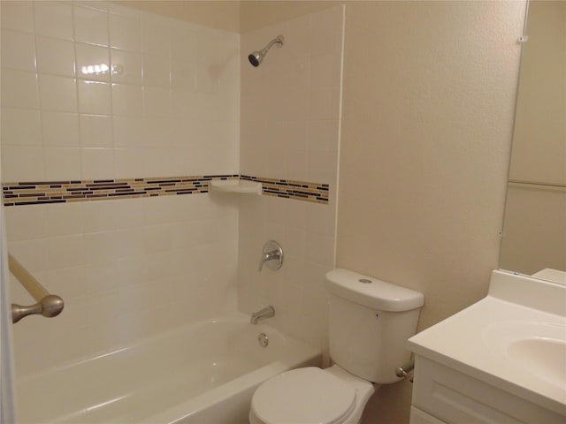 full bathroom featuring tiled shower / bath combo, vanity, and toilet