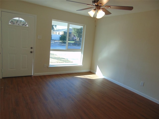 foyer entrance featuring dark wood-type flooring, a healthy amount of sunlight, and ceiling fan