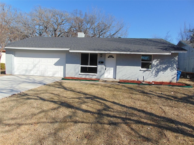 ranch-style house with a front yard and a garage