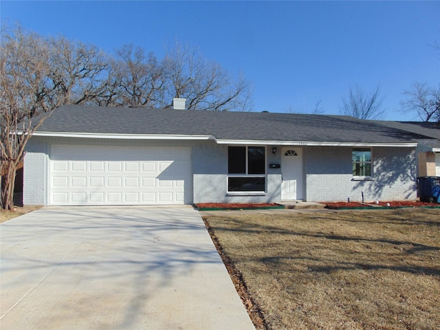 ranch-style house with a front yard and a garage