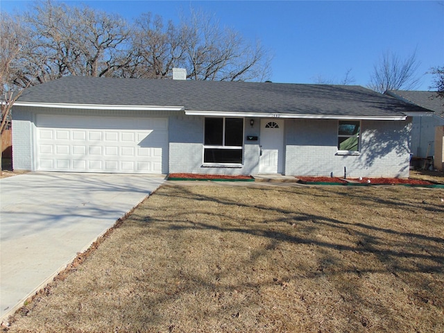 ranch-style home with a garage and a front lawn