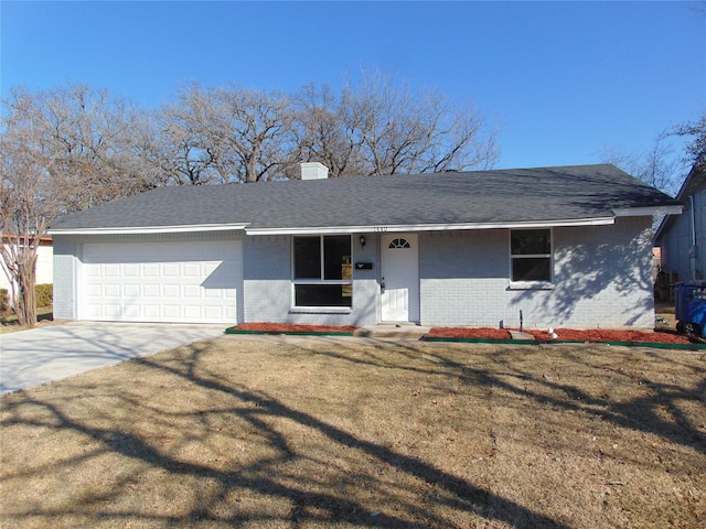 ranch-style home featuring a garage and a front lawn