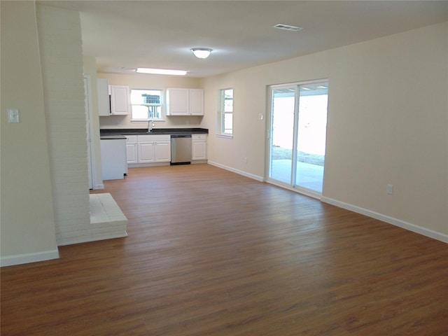 kitchen featuring dishwashing machine, dishwasher, white cabinetry, sink, and dark hardwood / wood-style floors