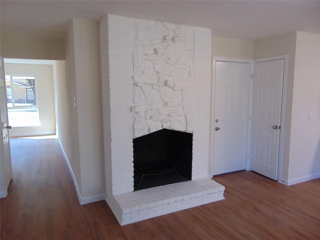 room details featuring a brick fireplace and hardwood / wood-style floors