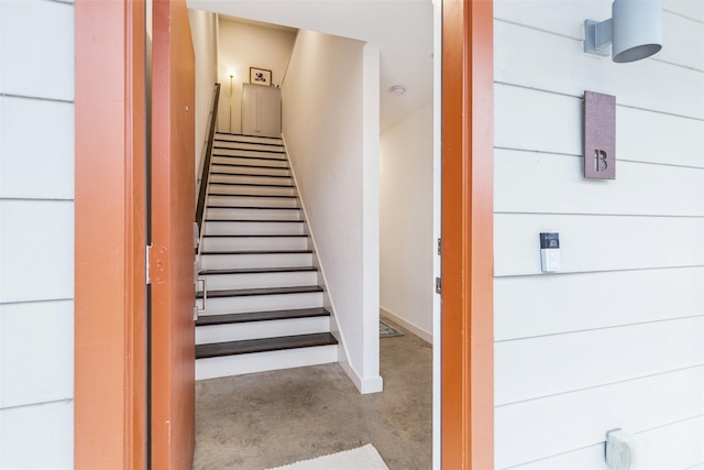 stairway featuring concrete floors