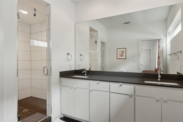 bathroom with vanity and an enclosed shower