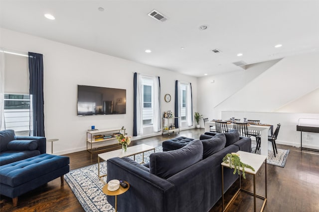 living room featuring plenty of natural light and dark hardwood / wood-style flooring