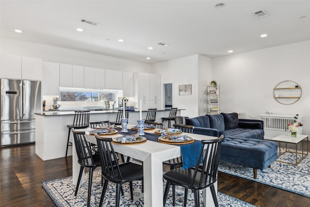 dining room with dark hardwood / wood-style flooring