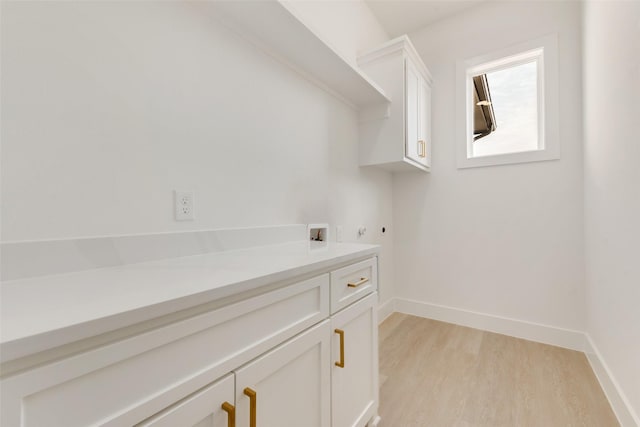 clothes washing area with light hardwood / wood-style floors, cabinets, hookup for a washing machine, and hookup for a gas dryer