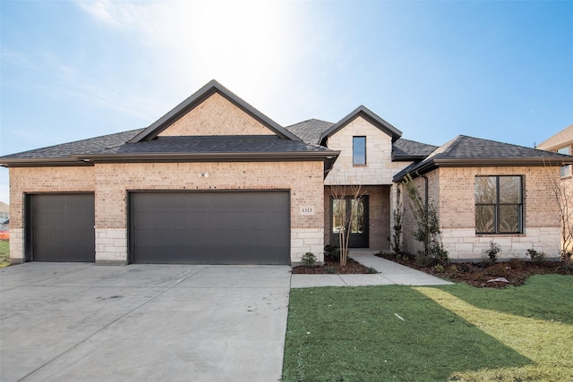 view of front of home with a garage and a front yard