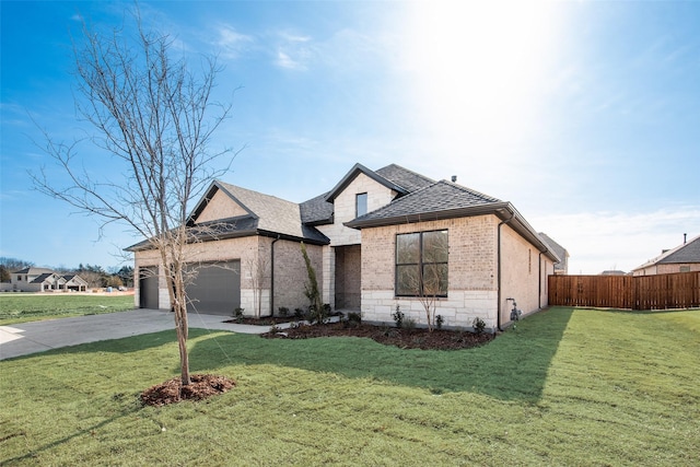 view of front of house featuring a front yard and a garage