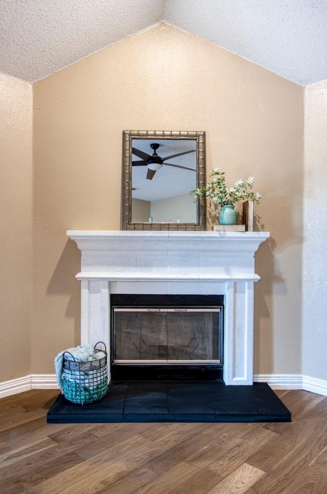 room details with hardwood / wood-style flooring and a tiled fireplace