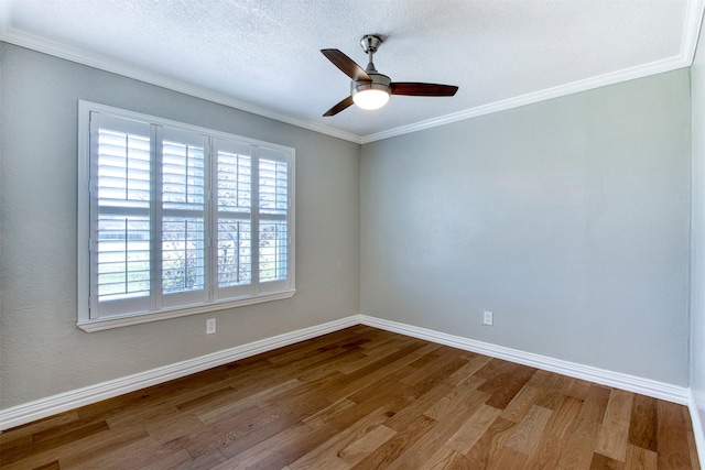 empty room featuring hardwood / wood-style flooring, ceiling fan, ornamental molding, and a textured ceiling