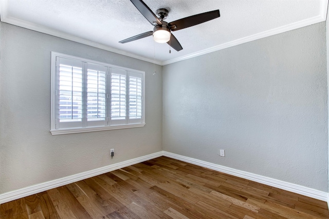 spare room with ceiling fan, crown molding, and wood-type flooring