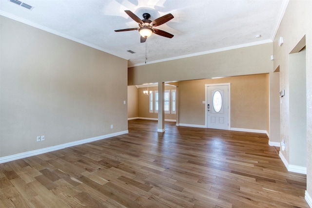 entryway featuring ceiling fan with notable chandelier, a textured ceiling, crown molding, and light wood-type flooring