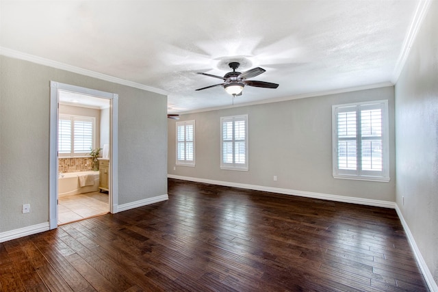 spare room featuring ceiling fan, crown molding, dark hardwood / wood-style floors, and a textured ceiling