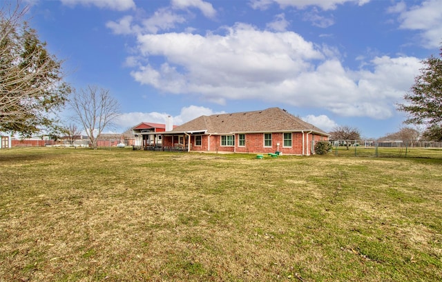 rear view of house with a yard