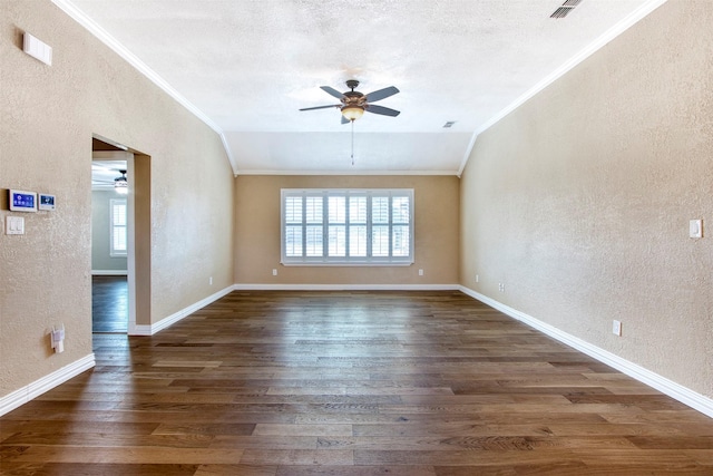 unfurnished room with crown molding, ceiling fan, dark hardwood / wood-style flooring, a textured ceiling, and lofted ceiling