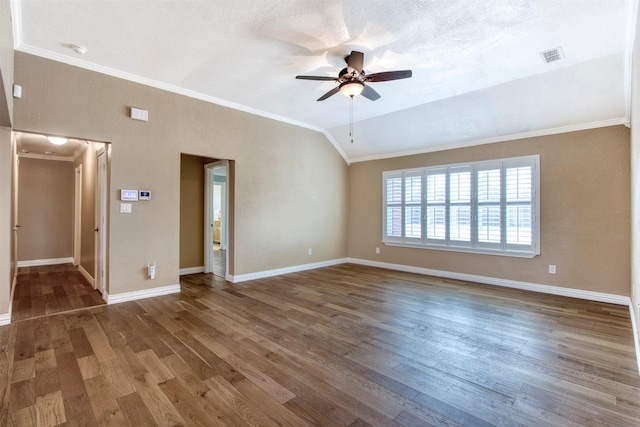 unfurnished room featuring crown molding, ceiling fan, a textured ceiling, dark hardwood / wood-style floors, and lofted ceiling