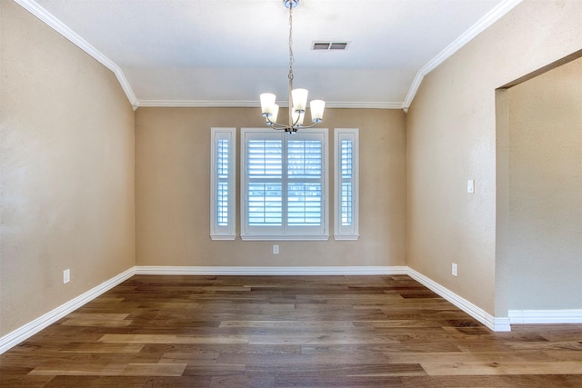 unfurnished room with hardwood / wood-style flooring, a notable chandelier, and ornamental molding